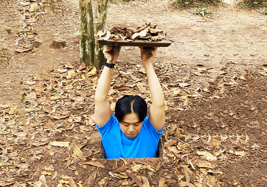 HCMC: Cu Chi Less-Crowded Ben Duoc Tunnels Half-Day Tour - Entering the Cu Chi tunnels the way attackers feared